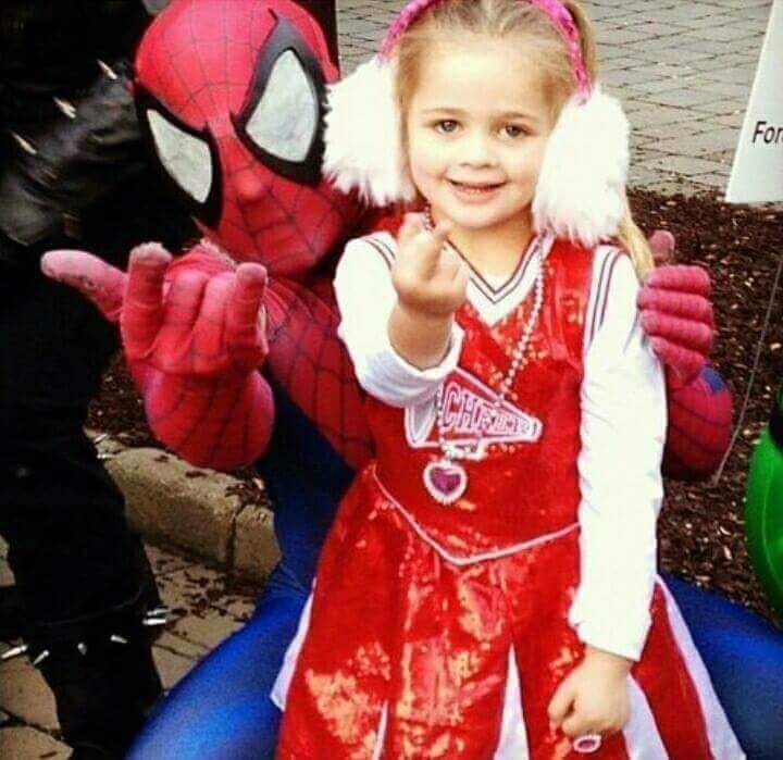 Spider-Man enseigne la sémiologie à une petite fille qui reproduit un doigt d'honneur.